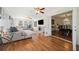 Open living room flowing into the dining room through glass paneled french doors, hardwood flooring, lots of natural light at 3200 Hampton Ridge Way, Snellville, GA 30078