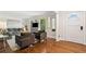 Living room with hardwood floors, modern seating, and a front door with decorative glass panels at 3200 Hampton Ridge Way, Snellville, GA 30078
