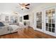 Spacious living room featuring hardwood floors, a large sectional sofa, and a fireplace at 3200 Hampton Ridge Way, Snellville, GA 30078