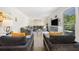 Bright living room featuring a large sectional sofa, modern armchairs, and stylish decor at 3200 Hampton Ridge Way, Snellville, GA 30078