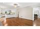 Open-concept living space with hardwood floors connecting the kitchen and living areas at 3200 Hampton Ridge Way, Snellville, GA 30078