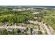 Aerial view of a residential community surrounded by lush green forest and distant quarry at 3601 Cedar Springs Ln, Loganville, GA 30052