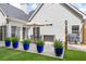 Spacious backyard patio with an umbrella, dining table, potted ferns, and grill at 3601 Cedar Springs Ln, Loganville, GA 30052