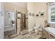 Bathroom featuring a walk-in shower and soaking tub with stone surround and tile flooring at 3601 Cedar Springs Ln, Loganville, GA 30052