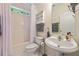 Bathroom featuring a shower/tub combo, a pedestal sink, and a window at 3601 Cedar Springs Ln, Loganville, GA 30052