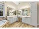 Bathroom featuring a vanity with double sinks and a soaking tub with stone surround and tile flooring at 3601 Cedar Springs Ln, Loganville, GA 30052