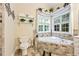 Well-lit bathroom features a soaking tub with stone surround and tile flooring at 3601 Cedar Springs Ln, Loganville, GA 30052