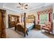 Traditional bedroom with a four poster bed, tray ceiling and decoratively patterned window treatments at 3601 Cedar Springs Ln, Loganville, GA 30052