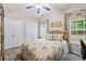 Bedroom with large window, ceiling fan and neutral walls at 3601 Cedar Springs Ln, Loganville, GA 30052