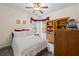 Bedroom with white walls, white bedding, neutral carpet, and a ceiling fan at 3601 Cedar Springs Ln, Loganville, GA 30052