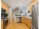 Kitchen with stainless steel appliances, wooden cabinets, granite countertops, and hardwood floors at 3601 Cedar Springs Ln, Loganville, GA 30052
