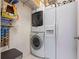 Laundry room with stacked washer/dryer and white refrigerator at 3601 Cedar Springs Ln, Loganville, GA 30052