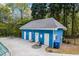 View of the community pool house with doors, surrounded by greenery and a pool at 3601 Cedar Springs Ln, Loganville, GA 30052