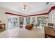Bright sunroom with tile floors, numerous windows, and a view of the outdoor patio area at 3601 Cedar Springs Ln, Loganville, GA 30052