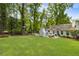 This spacious backyard features a large lawn, patio seating area and playground at 568 Timberland Dr, Atlanta, GA 30342