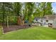 Spacious backyard features a playground, large lawn, and patio seating area at 568 Timberland Dr, Atlanta, GA 30342