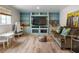 Inviting finished basement area with built-in shelving, seating, and light wood floors at 568 Timberland Dr, Atlanta, GA 30342