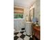 Quaint bathroom with patterned wallpaper, a pedestal sink, and a window at 568 Timberland Dr, Atlanta, GA 30342