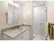 Bright bathroom with a marble countertop vanity and a glass-enclosed shower with white subway tile at 568 Timberland Dr, Atlanta, GA 30342