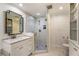 Modern bathroom with a glass-enclosed shower, marble countertops, and built-in storage at 568 Timberland Dr, Atlanta, GA 30342