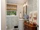 Quaint bathroom with patterned wallpaper, a pedestal sink, and a window at 568 Timberland Dr, Atlanta, GA 30342