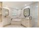 Elegant bathroom showcasing a soaking tub, dual vanities with marble countertops, and a glass shower at 568 Timberland Dr, Atlanta, GA 30342