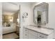 Elegant bathroom featuring a marble countertop vanity, decorative mirror, and a glimpse into the main bedroom at 568 Timberland Dr, Atlanta, GA 30342