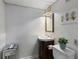 Compact powder room featuring a dark vanity, and modern fixtures at 568 Timberland Dr, Atlanta, GA 30342