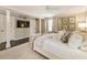 Comfortable bedroom featuring neutral tones, a mounted TV, and hardwood floors at 568 Timberland Dr, Atlanta, GA 30342