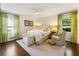 Inviting bedroom with hardwood floors, green accents, natural light, and comfortable seating at 568 Timberland Dr, Atlanta, GA 30342