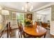 Elegant dining room featuring a wood table, floral wallpaper, and natural light from a window at 568 Timberland Dr, Atlanta, GA 30342