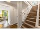 Bright foyer with carpeted staircase and a glimpse into a sunlit living room at 568 Timberland Dr, Atlanta, GA 30342