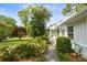 Stone walkway leads to a quaint front entrance with white trim and lush landscaping at 568 Timberland Dr, Atlanta, GA 30342