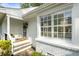 Close-up of the front entrance with stone steps and charming white exterior at 568 Timberland Dr, Atlanta, GA 30342