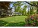 Lush front yard with blooming azaleas and mature trees surrounding a lovely home at 568 Timberland Dr, Atlanta, GA 30342