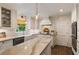Modern kitchen with a marble-top island, stainless steel appliances, stylish lighting, and updated finishes at 568 Timberland Dr, Atlanta, GA 30342