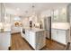 Spacious kitchen featuring a marble-top island, stainless steel appliances, and stylish pendant lighting at 568 Timberland Dr, Atlanta, GA 30342