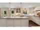 Modern kitchen with farmhouse sink, stainless steel appliances, marble countertops and herringbone backsplash at 568 Timberland Dr, Atlanta, GA 30342