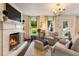 Cozy living room with a fireplace, ample natural light, and access to outdoor space at 568 Timberland Dr, Atlanta, GA 30342