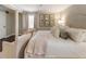 Bright main bedroom with neutral decor, sitting area, floral artwork, and a large comfortable bed at 568 Timberland Dr, Atlanta, GA 30342