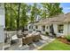 Charming outdoor patio featuring an outdoor fireplace, comfortable seating, and a beautifully landscaped yard at 568 Timberland Dr, Atlanta, GA 30342