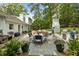 Large outdoor patio features dining, fireplace, grill, and seating areas, perfect for outdoor living at 568 Timberland Dr, Atlanta, GA 30342