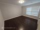 Bedroom with dark wood floors and window with blinds at 7030 Bennington Ln, Cumming, GA 30041