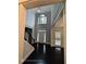 Grand foyer with soaring ceilings, dark hardwood floors, elegant lighting, and a view to the front door at 7030 Bennington Ln, Cumming, GA 30041