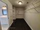 Spacious walk-in closet with dark wood floor and abundant metal shelving at 7030 Bennington Ln, Cumming, GA 30041