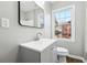 Well-lit bathroom features a modern vanity, mirror, and window for natural light at 1870 Oak Valley Rd, Decatur, GA 30035