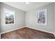 This bedroom features hardwood floors, neutral walls, and windows overlooking the yard at 1870 Oak Valley Rd, Decatur, GA 30035