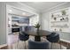 Open dining area flowing into a kitchen with stainless appliances and painted cabinets at 1870 Oak Valley Rd, Decatur, GA 30035