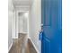 Hallway featuring wood-look floors, neutral walls, and a vibrant blue door creating a welcoming entrance at 1870 Oak Valley Rd, Decatur, GA 30035
