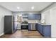 Well-lit kitchen features stainless appliances, gray countertops and dark blue cabinets at 1870 Oak Valley Rd, Decatur, GA 30035